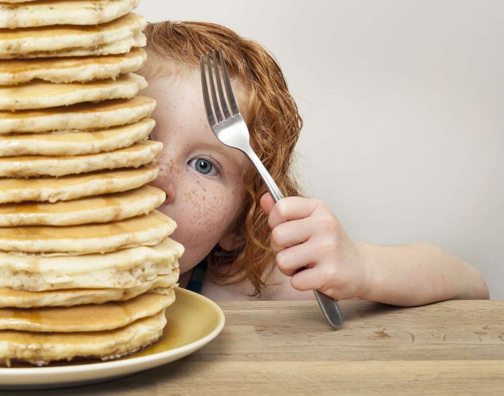 Child enjoying pancakes